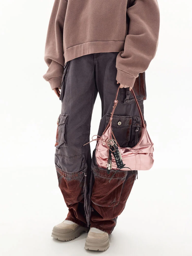 The lace-up charm adds edge to the pink metallic Kadee bag.