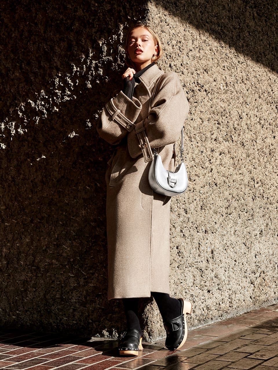 Women’s Gabine metallic leather belted hobo bag in silver and Women’s Gabine studded leather clogs in black, as seen on Jess Alexander - CHARLES & KEITH