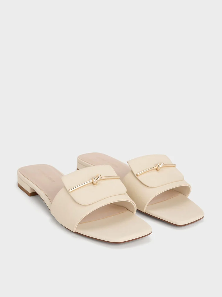 Slides feature singular vamp straps that hold the foot in place. 