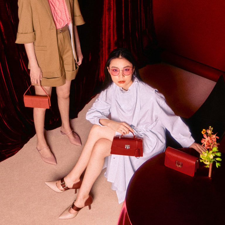 Women’s oversized buckle pointed toe pumps, sculptural heel pointed toe mules, trapeze top handle bag, panelled long wallet and stone-embellished envelope bag – CHARLES & KEITH