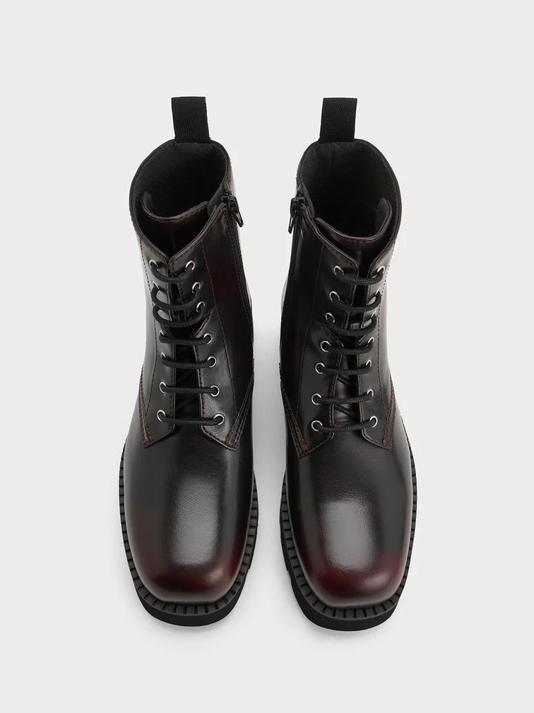 Burgundy combat ankle boots with classic lace-up design and ridged soles.