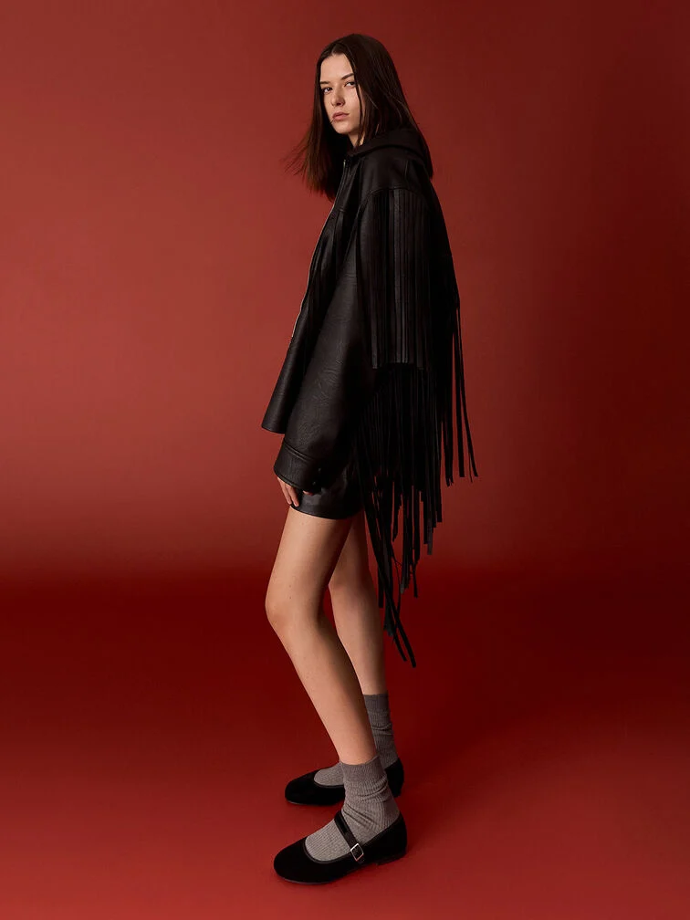 Velvet Mary Janes styled with socks and a fringed jacket.