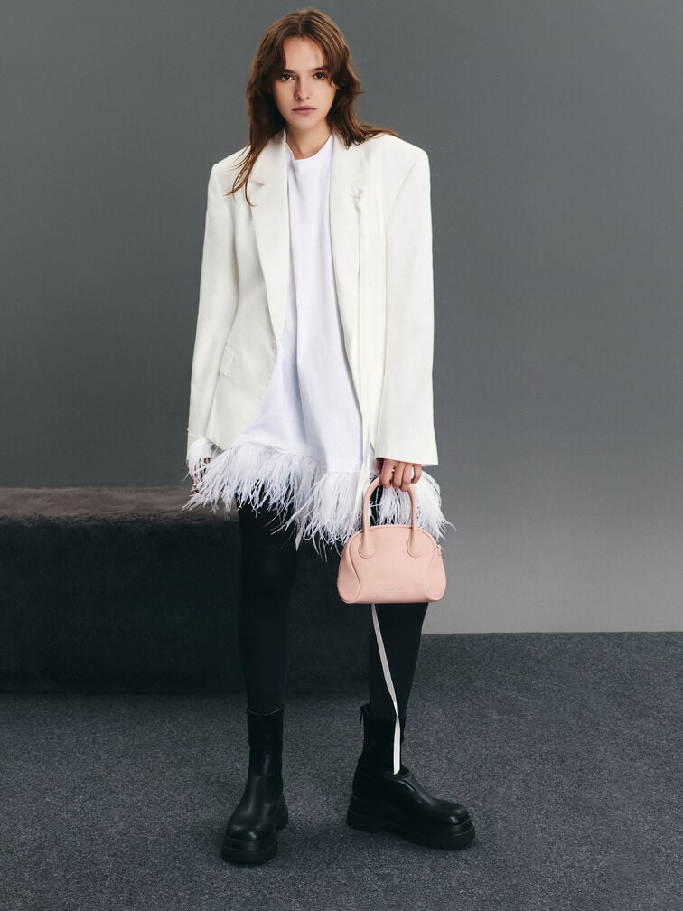 A structured top-handle bag creates a polished and put-together look. 