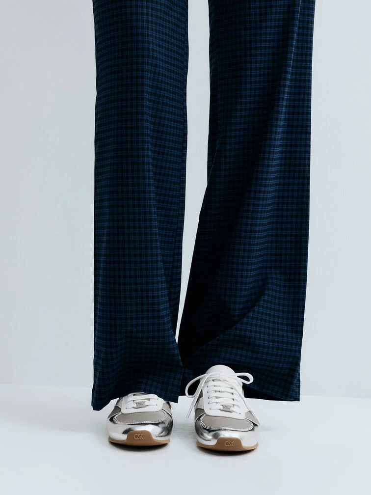  Balance the shine of metallic low-profile trainers with softly draped wide-leg trousers in a subtle check print to create a bold but tasteful combination. 