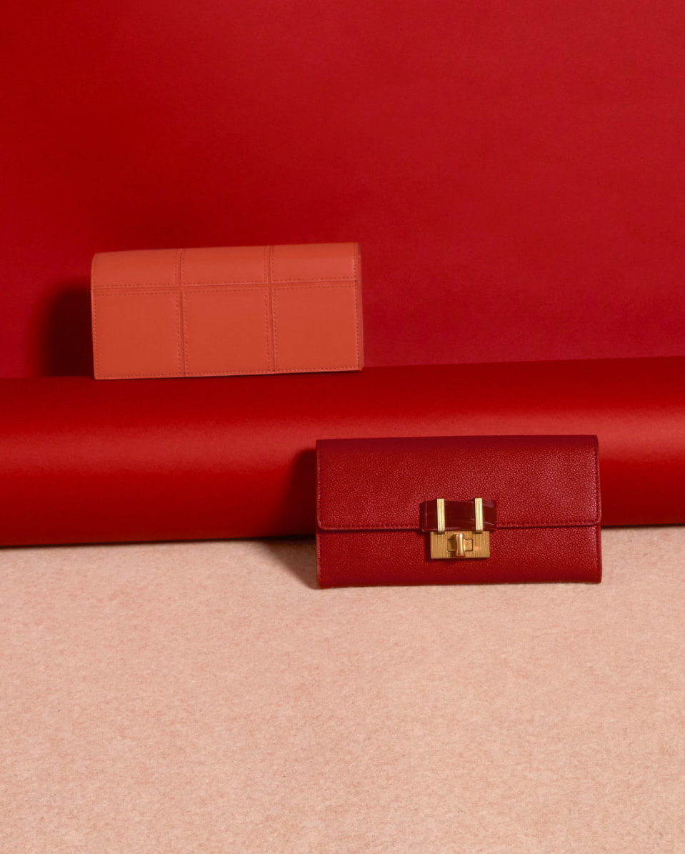 Women’s stone-embellished long wallet in red and panelled long wallet in coral – CHARLES & KEITH