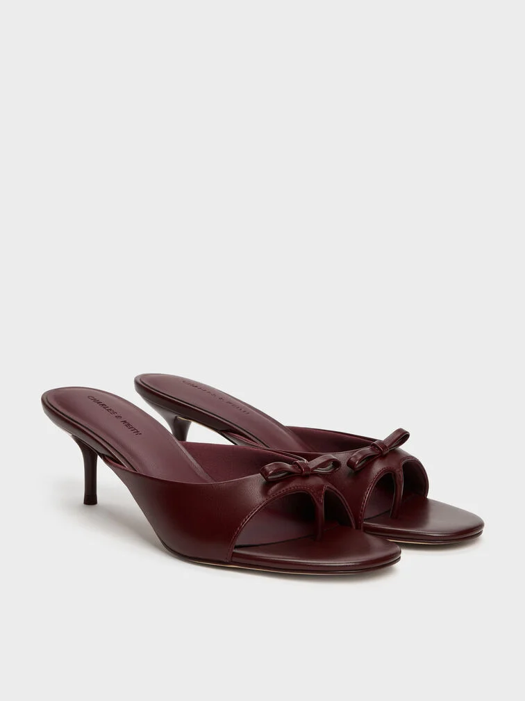 Heeled bow thong sandals in deep, jewel-inspired burgundy.