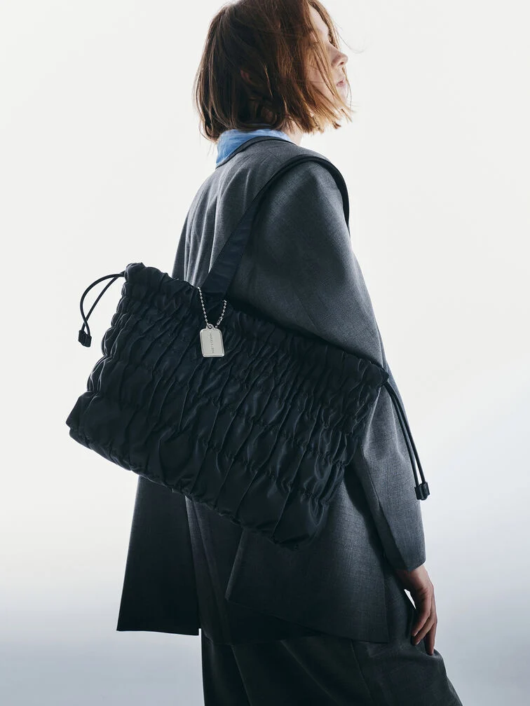 Large, black quilted tote bags are popular choice for professional, working women.