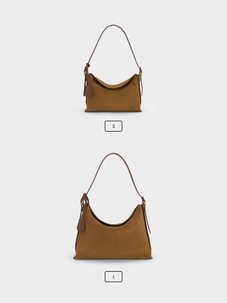 The L’Initial leather hobo bag is available in small and large sizes, shown side by side.