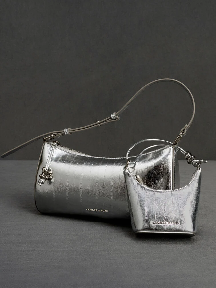 The Augustine micro bag charm paired with the Augustine shoulder bag.
