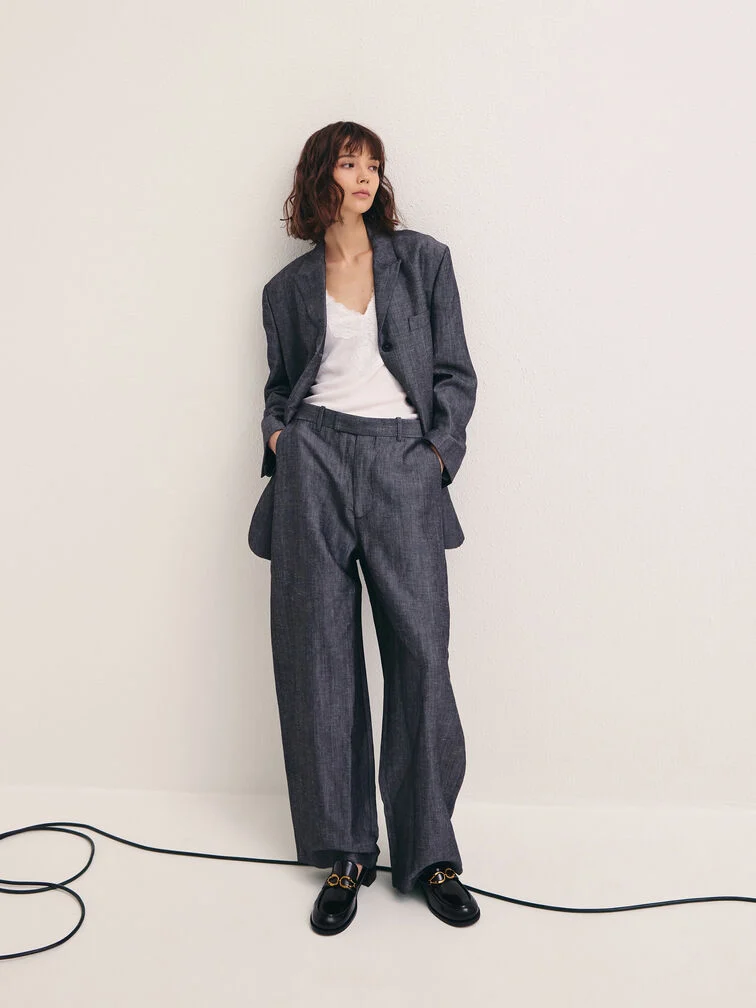 Black loafers styled with a blazer-and-trousers ensemble for an effortlessly polished office-ready look.