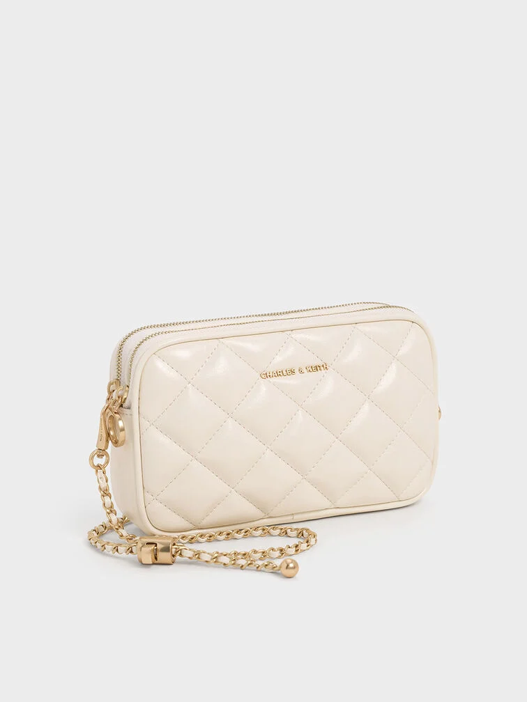 A cream chain-handle bag will elevate your look.  