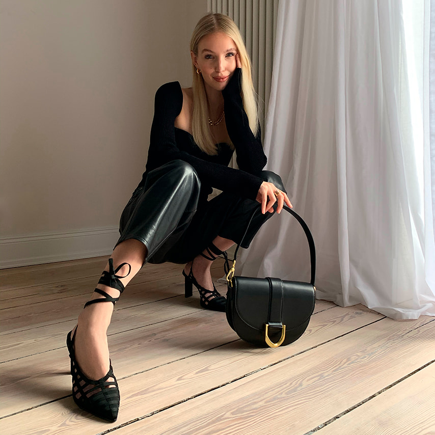 Leonie Hanne with our Gabine saddle bag in black and grosgrain tie-around caged pumps in black – CHARLES & KEITH