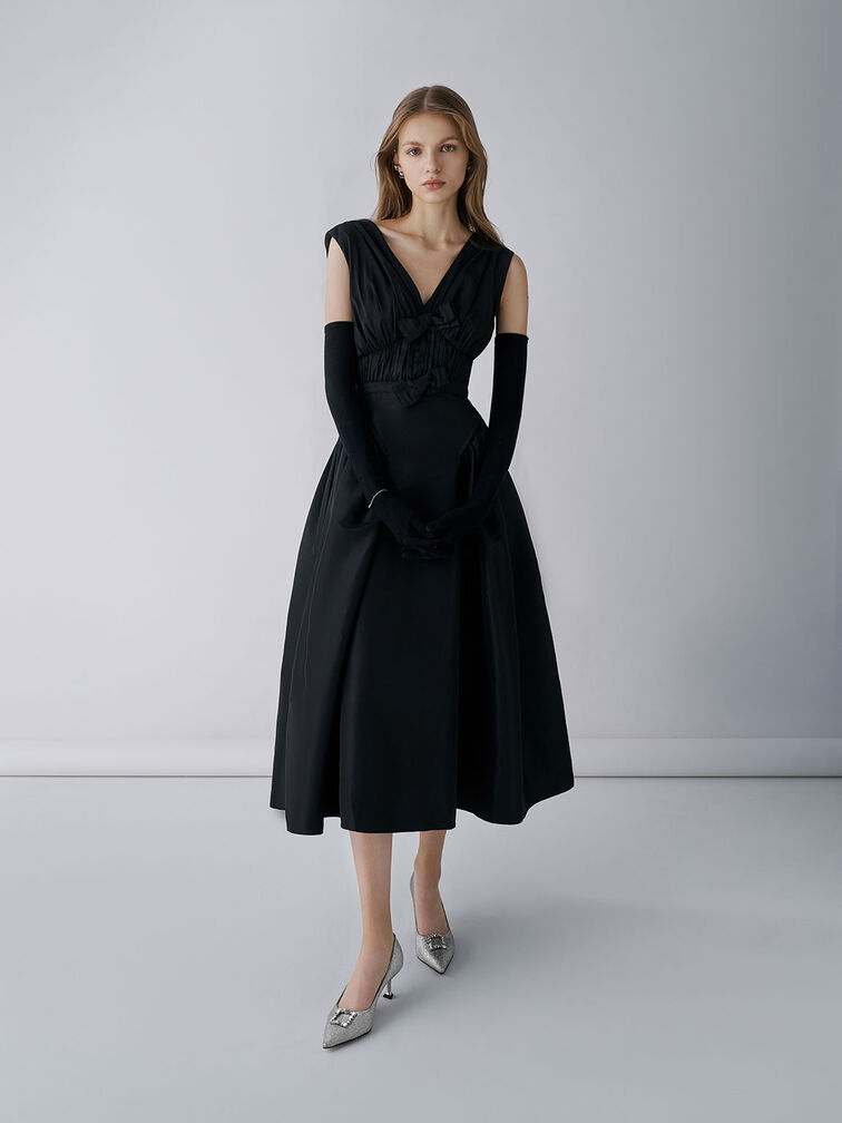 Glittered pointed-toe pumps paired with a formal black dress