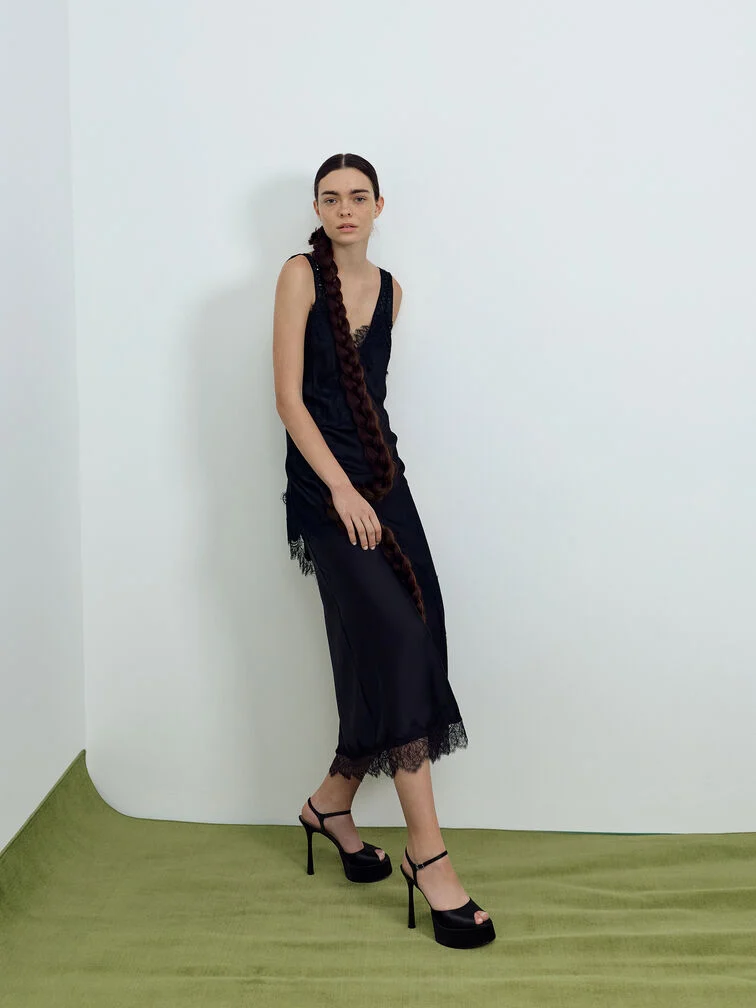 Peep-toe platform heels paired with a maxi lace dress to create a flattering, elongated silhouette.