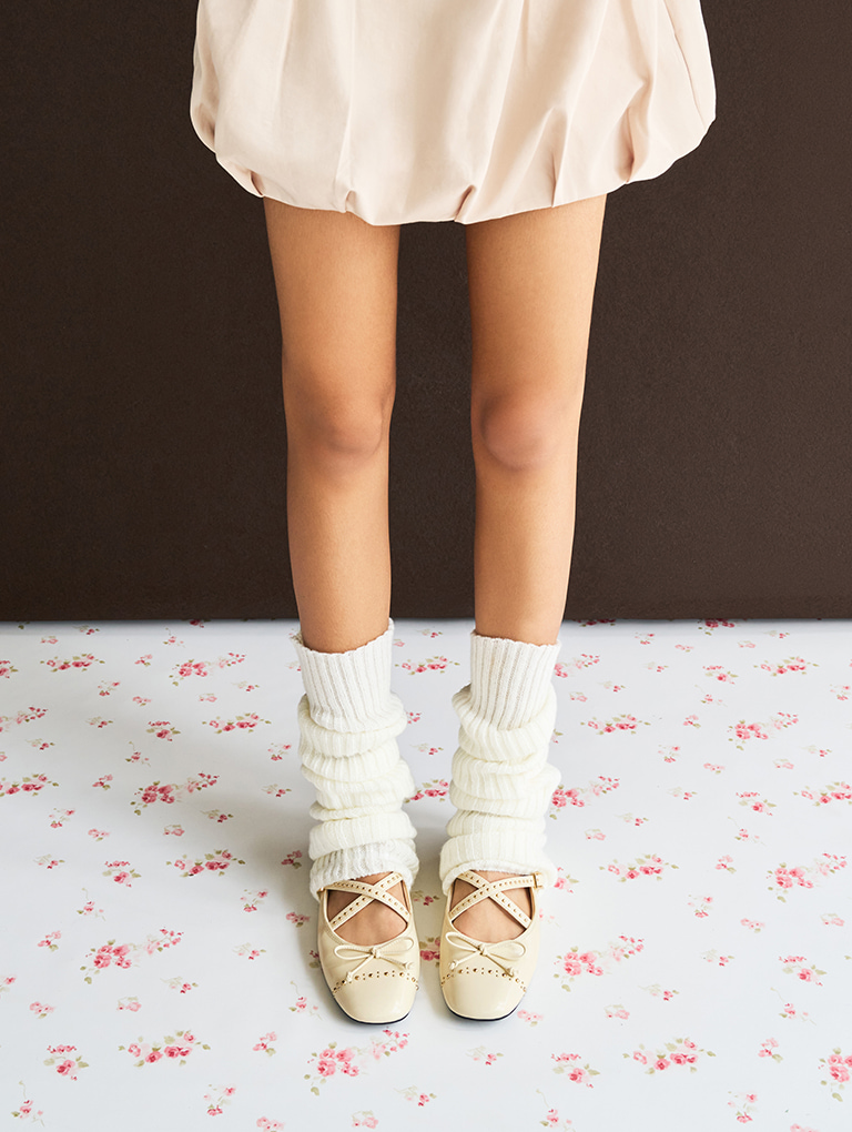 Women’s studded crossover-strap Mary Jane flats in chalk, styled with matching leg warmers – CHARLES & KEITH