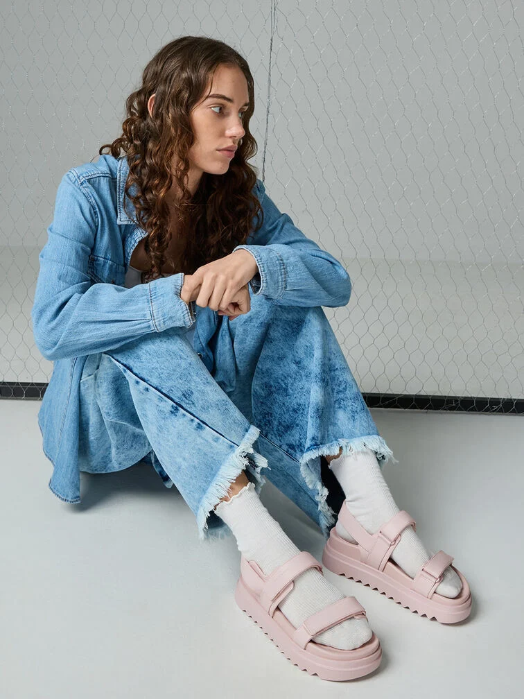 Wear pink sandals with white socks to soften the utilitarian, workman-esque aesthetic of a denim shirt-and-jeans pairing 