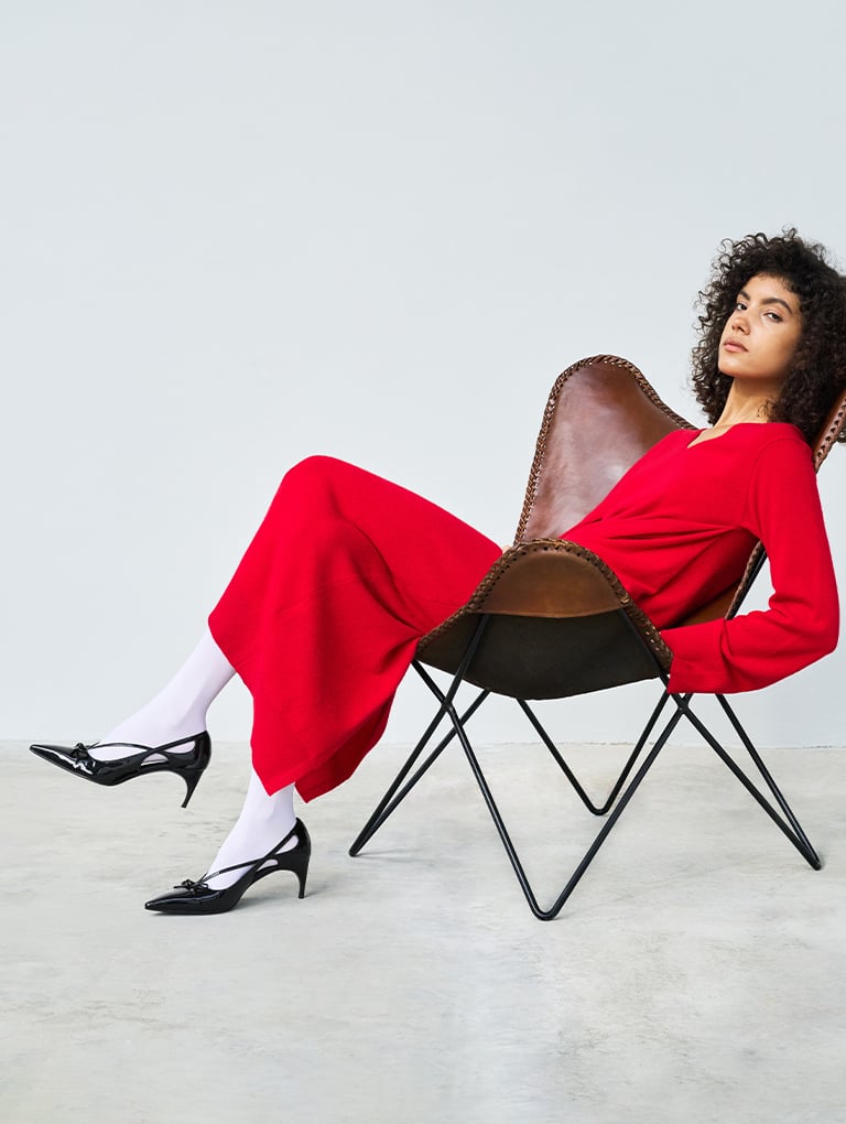 Women’s patent cut-out bow kitten-heel pumps in black (on model) – CHARLES & KEITH