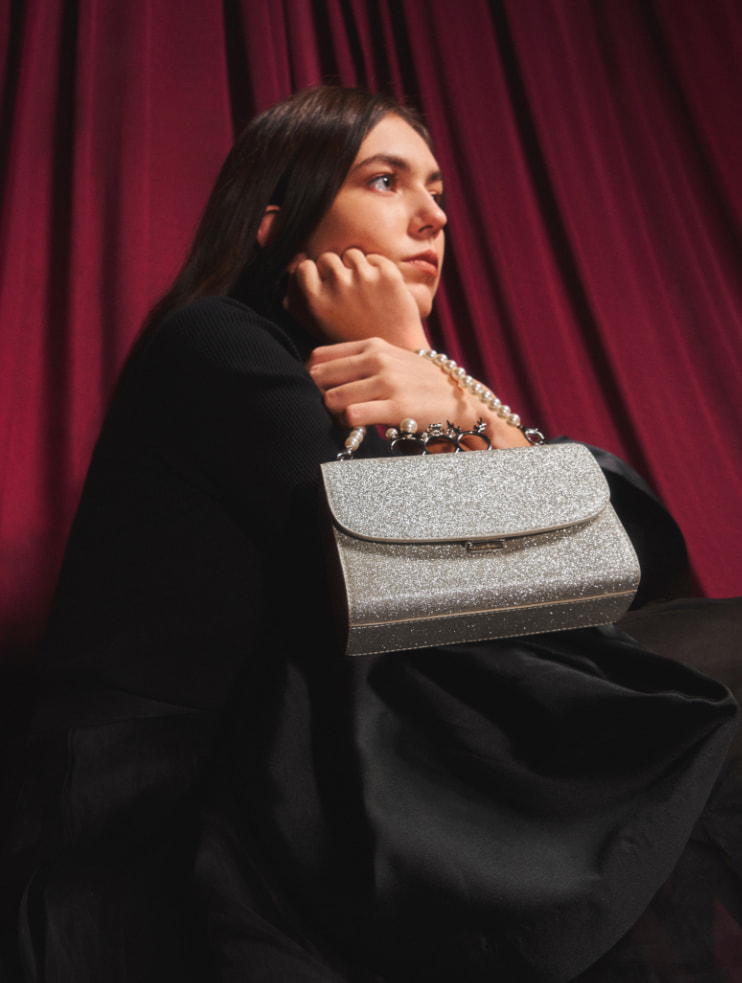 Women’s glittered ribbon ankle-tie sandals in black and glittered knuckle-ring clutch in silver – CHARLES & KEITH