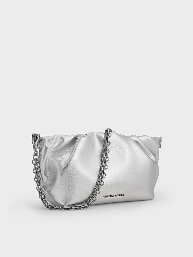 Metallic ruched clutch with chain strap, a striking choice for the holiday and festive season.