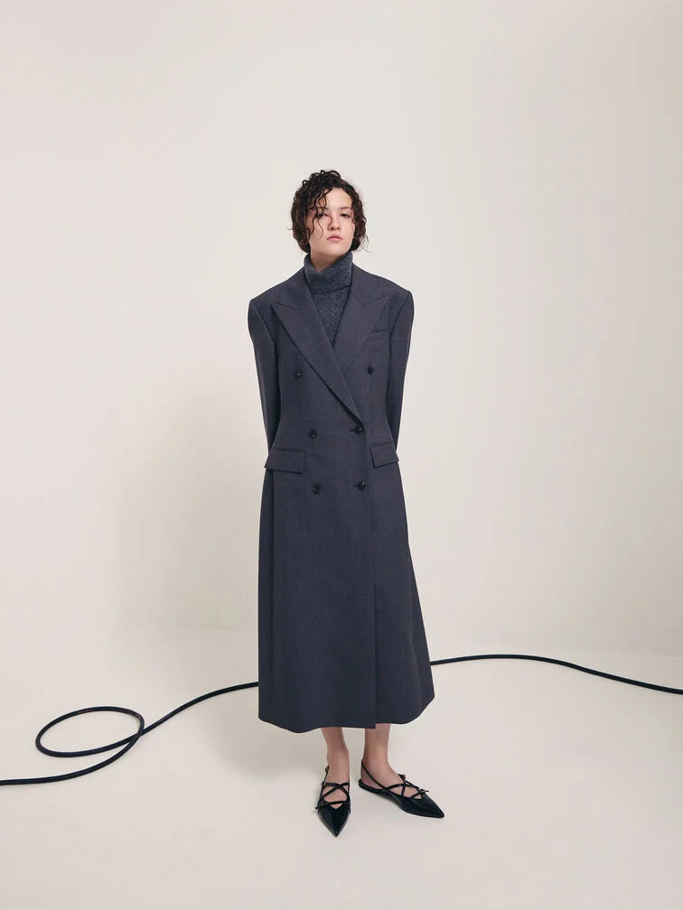 Patent pointed-toe slingback flats paired with a tailored blazer dress for a polished finish.