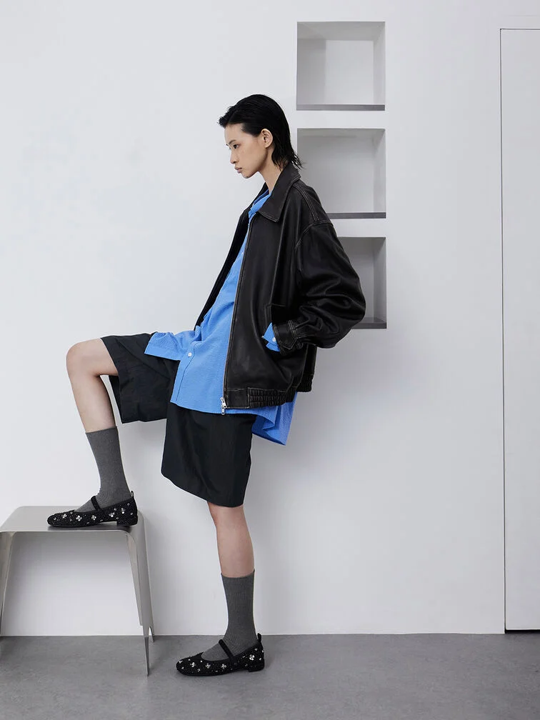 Tweed Mary Janes styled with socks, a button-up shirt and shorts.