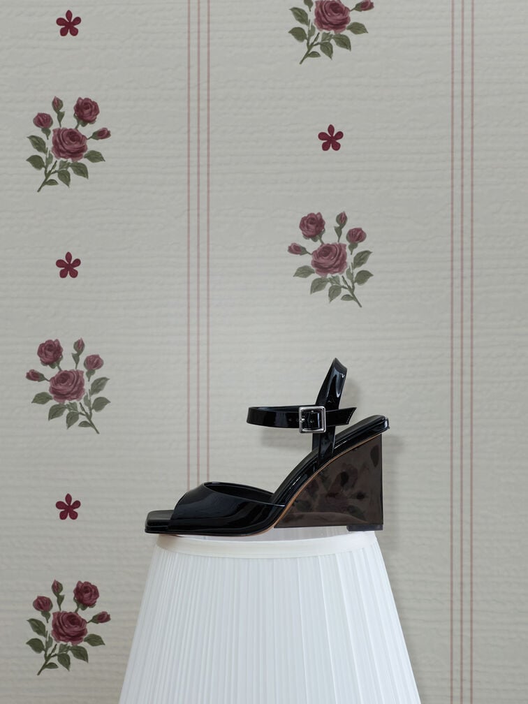Black patent sandals with translucent wedge heels are versatile and statement-making at the same time. 