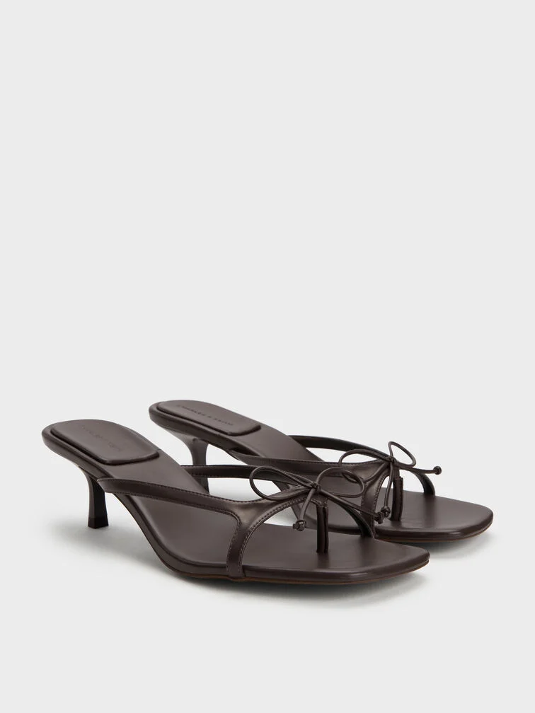 Dark brown bow thong kitten heels with square toes, perfectly polished for party wear.