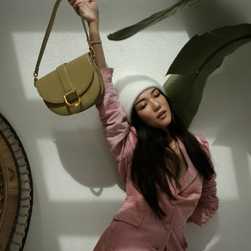 Yoyo Cao with our Gabine saddle bag in khaki – CHARLES & KEITH