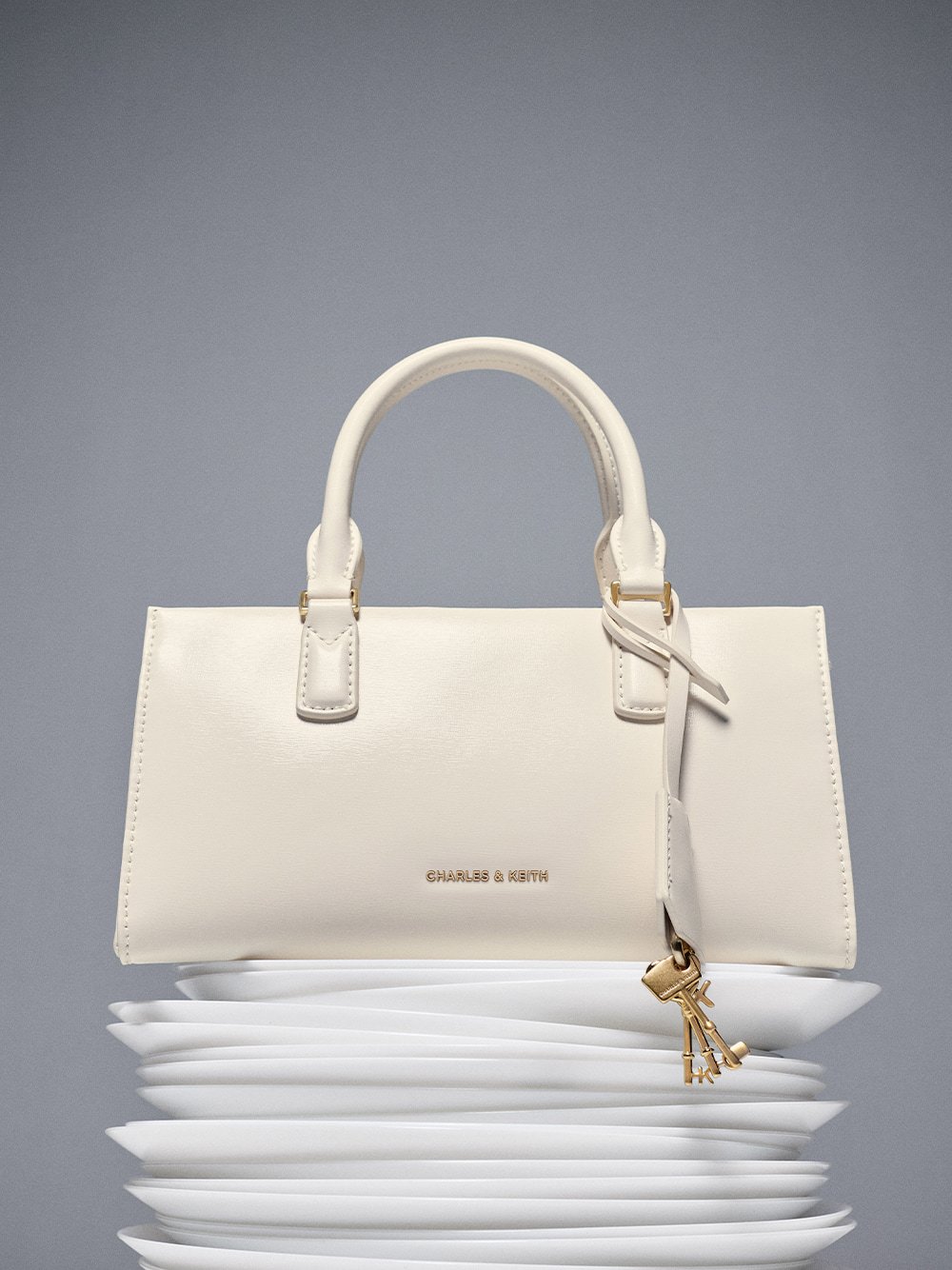 Mini Kerry Top Handle Bag in cream - CHARLES & KEITH