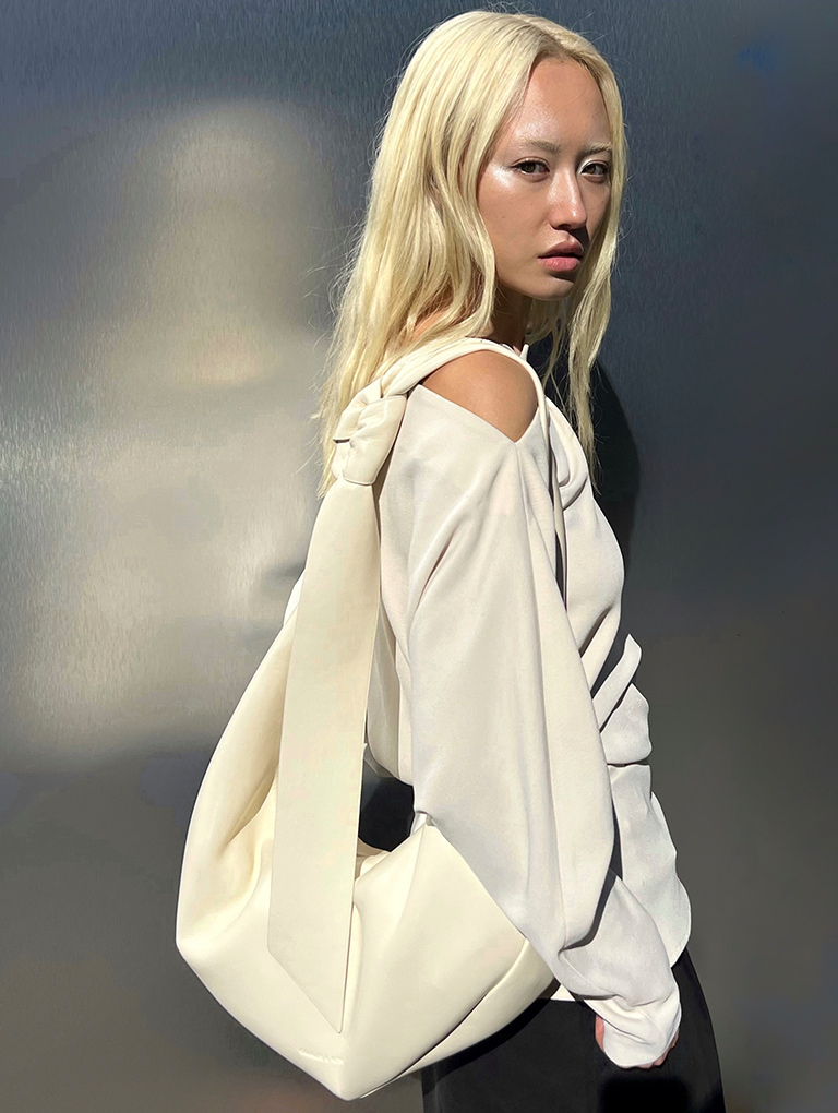 Women’s Toni Knotted Curved Hobo Bag in chalk, as seen on Dechen Grenfell – CHARLES & KEITH