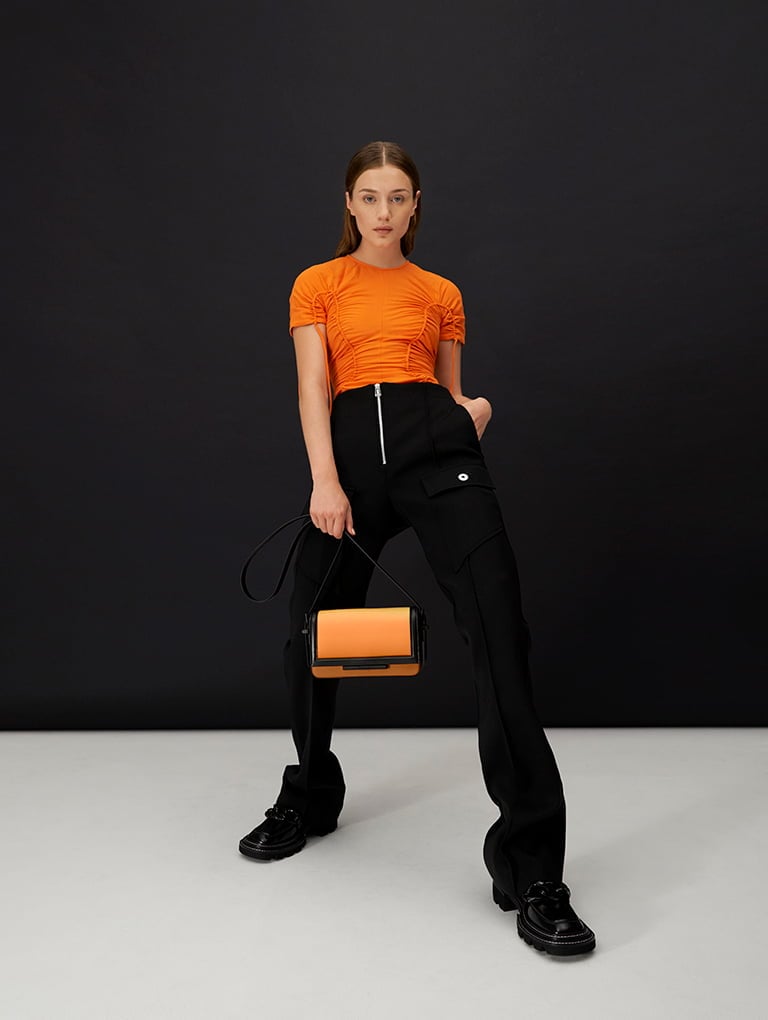 Cesia Crossbody Bag in sunset and Perline Chunky Chain Loafers in black; Lana Curved Shoulder Bag in black and Hayden Bead-Embellished Patent Boots in black; Verity Chain-Link Sculptural Bag in white and Quilted Chain Loafer Mules in chalk  - CHARLES & KEITH