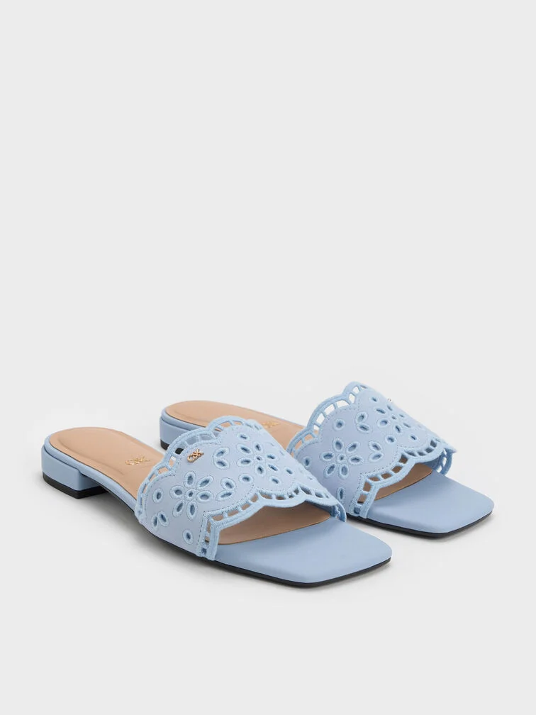 Leather slide sandals with embroidered straps in light blue.