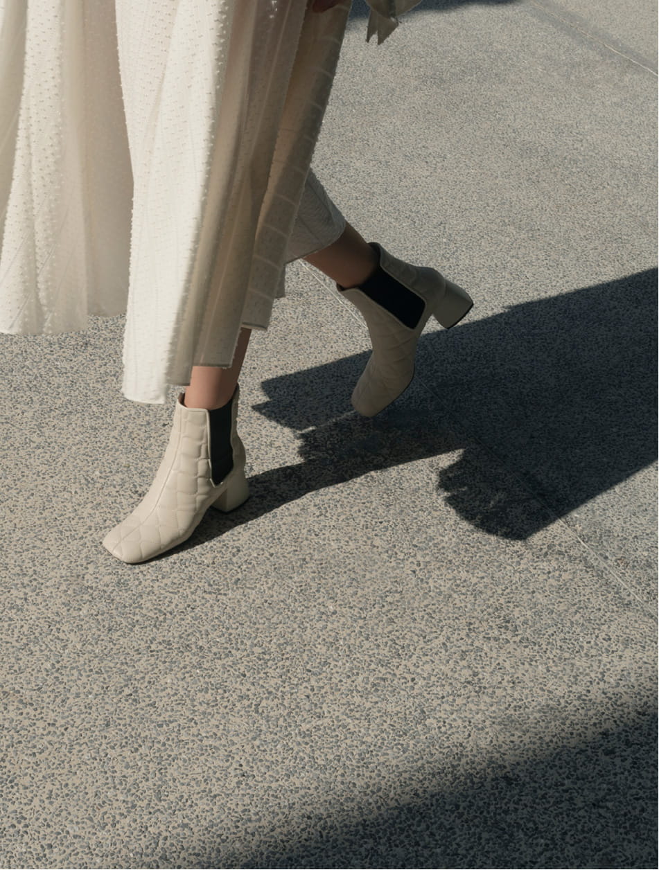 Women’s quilted leather Chelsea boots in chalk (side view) – CHARLES & KEITH