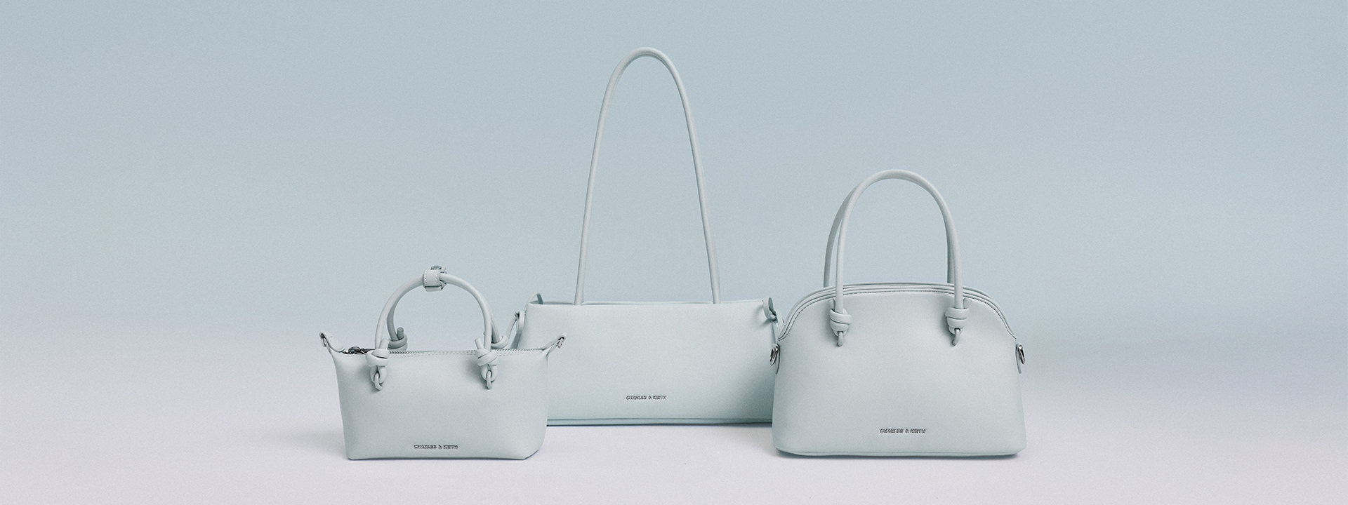 Women’s Hazel Bow Elongated Trapeze Shoulder Bag in Sea Salt Blue, Sammie Knotted-Handle Tote Bag in Sea Salt Blue and Sammie Knotted-Handle Bowling Bag in Sea Salt Blue - CHARLES & KEITH