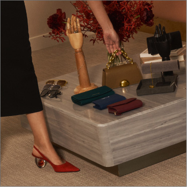 Women’s small taupe chain strap bag, red sculptural heel pumps, assorted mini bags and wallets – CHARLES & KEITH
