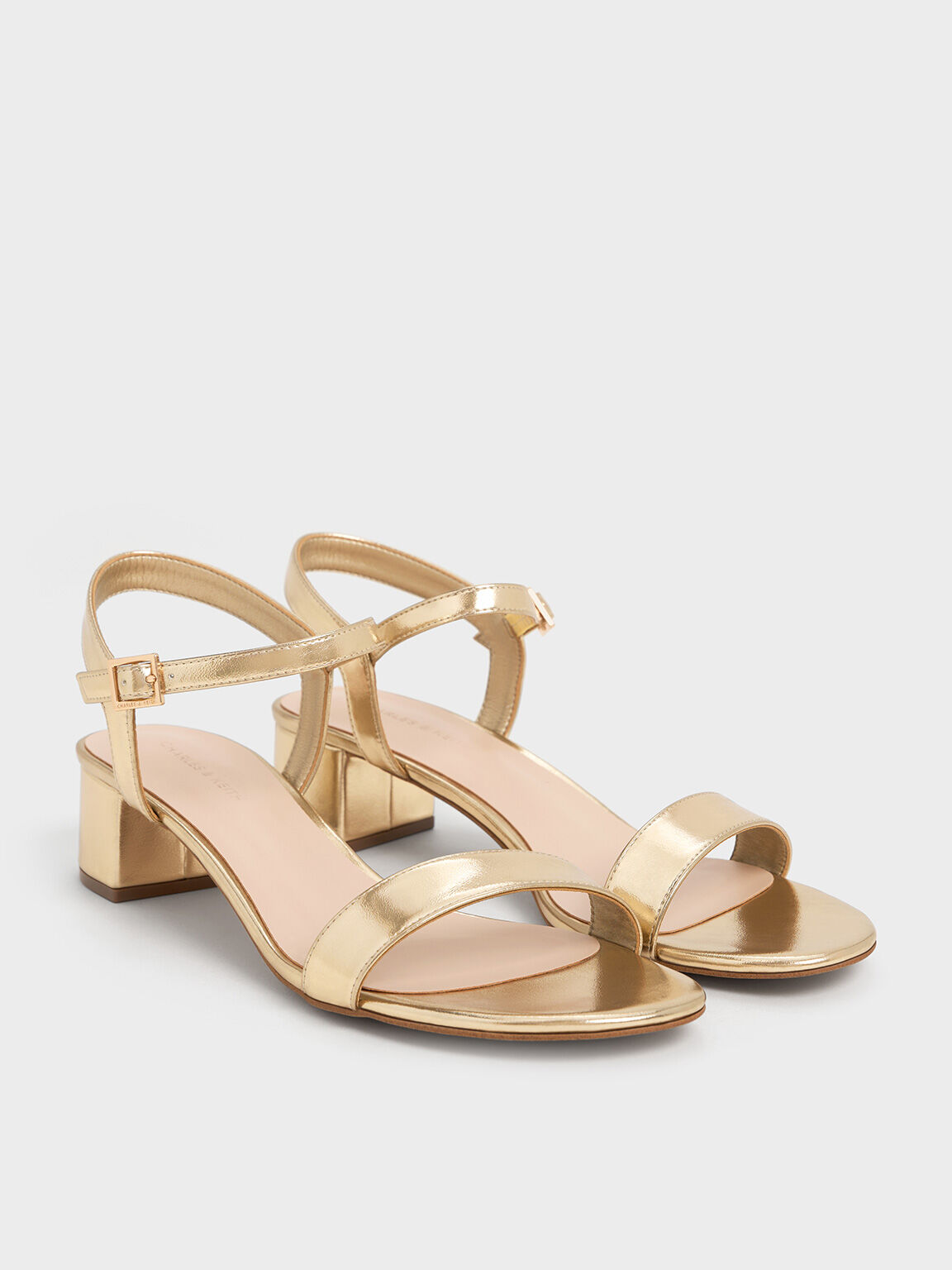 Light gold block-heel ankle-strap sandals, an elevated yet comfortable option for party wear.