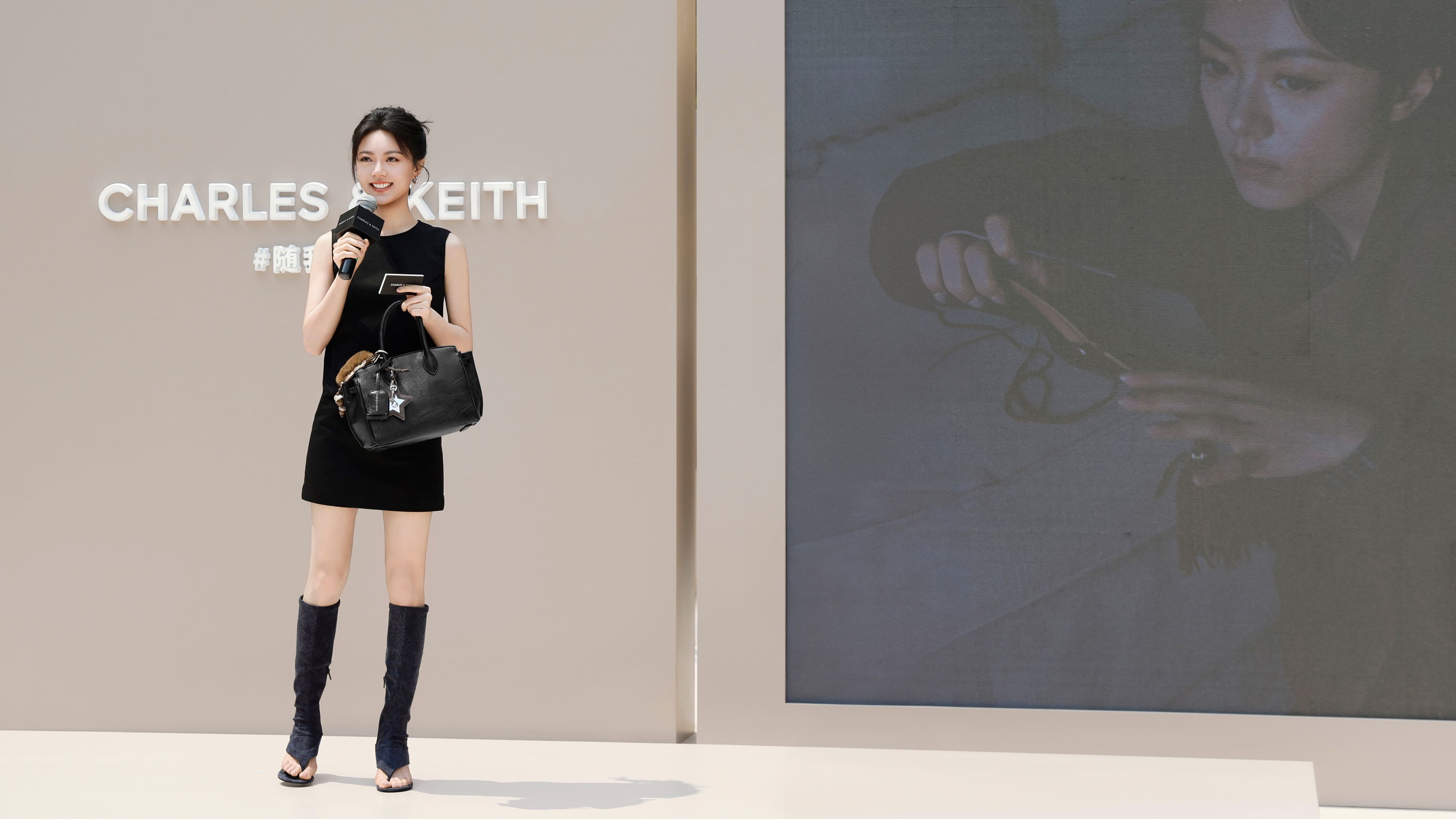 Women’s Ginevra tote bag and Aether thong boots in matching black, as seen on Zhao Jinmai - CHARLES & KEITH