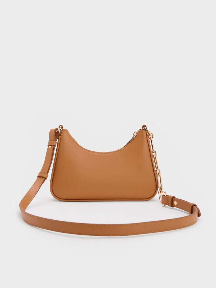  A neutral brown crossbody bag allows you to go hands-free.  