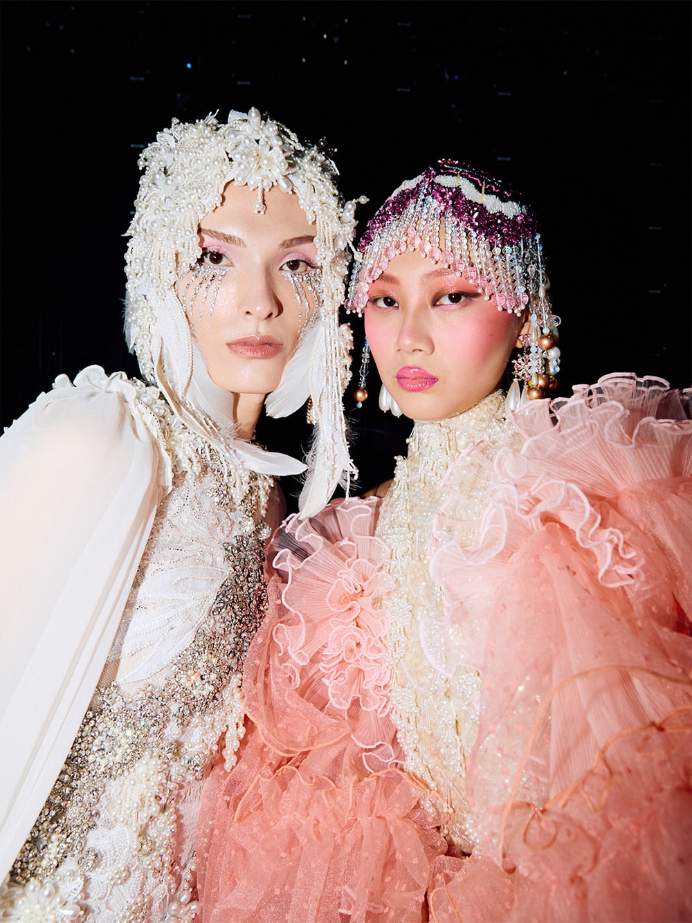 Two models pose backstage at the Romance Was Born show during Australia Fashion Week 2025 - CHARLES & KEITH