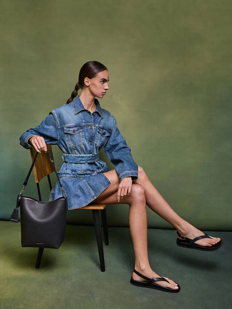 Create a neat and flattering visual line by matching a cropped fitted denim jacket with a flared denim mini skirt 