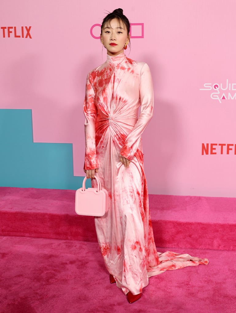 Women’s Perline sculptural top-handle bag in pink and bow pointed-toe stiletto heel pumps in red, as seen on Gia Kim - CHARLES & KEITH