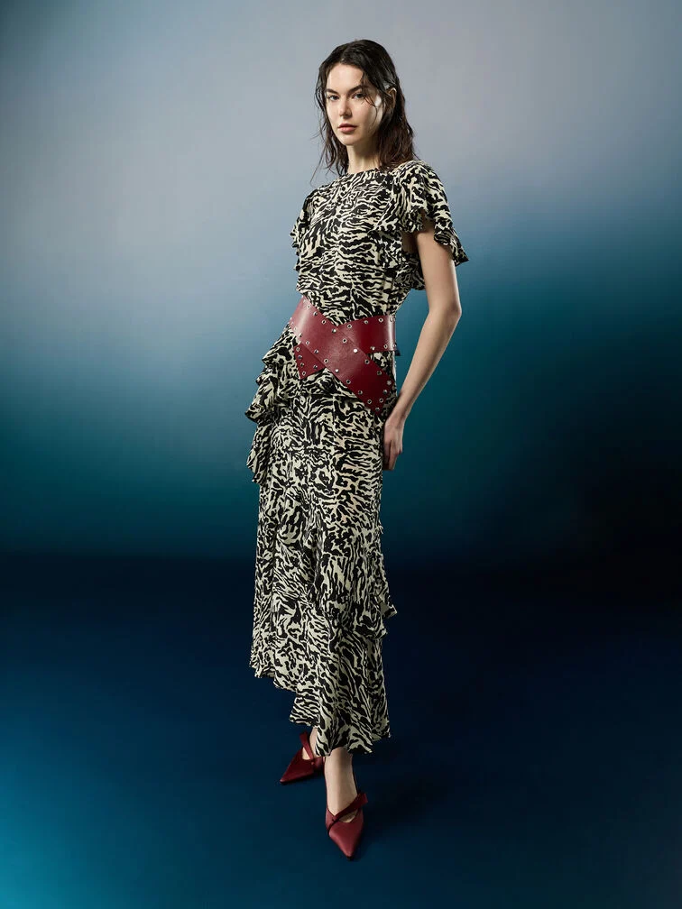 Sleek, minimalist slingback pumps paired with a boldly patterned maxi dress to create a balanced look.