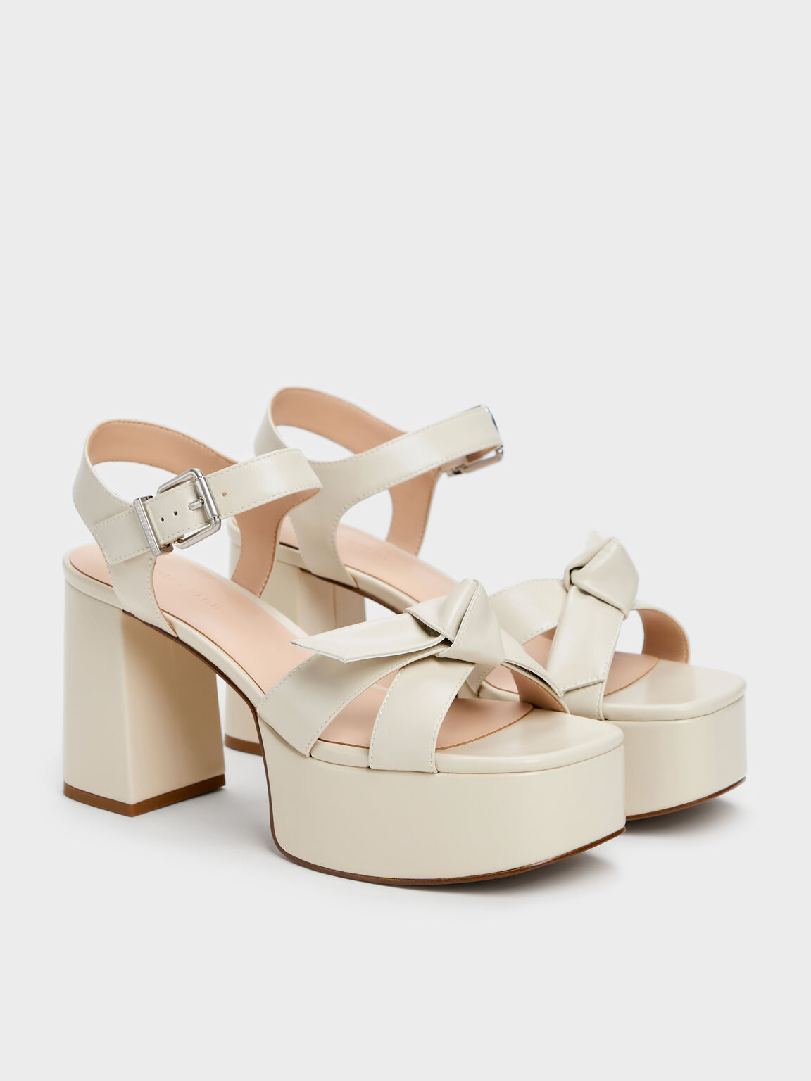 Chalk-white knot-bow platform sandals, an excellent alternative to stilettos.