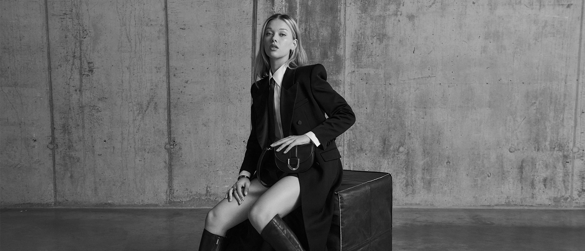 Women’s Gabine Leather Knee-High Boots in black; Mini Gabine Saddle Bag in black, Gabine Chain-Link Ring in black, Gabine Swarovski Crystal Chain-Link Ring in silver; Gabine Cuff Bracelet in black; Gabine Chain-Link Ring in black, as seen on Jess Alexander - CHARLES & KEITH