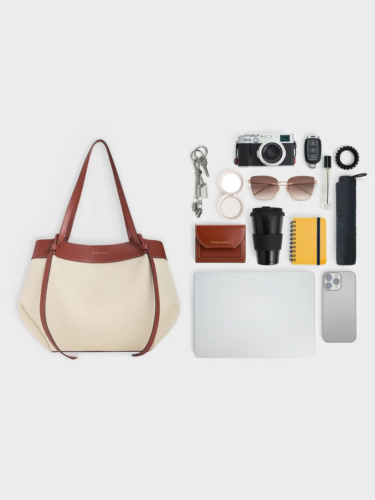 Everything that can fit into the XL Calla tote, including a laptop, wallet, water bottle, umbrella and more.