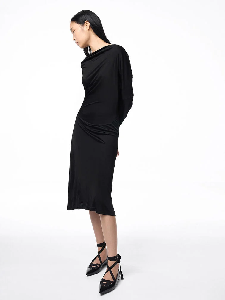 Black pointed-toe tie-around flats complement a festive aesthetic.