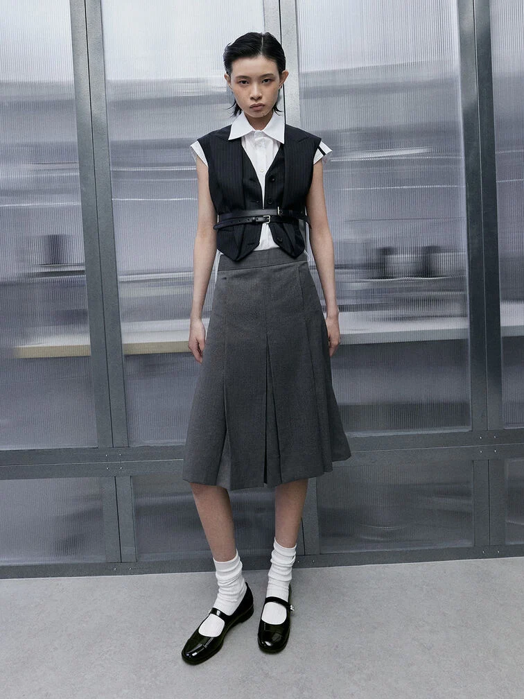 Monochromatic outfit completed with black Mary Janes and white ribbed socks for a cohesive, stylish look. 