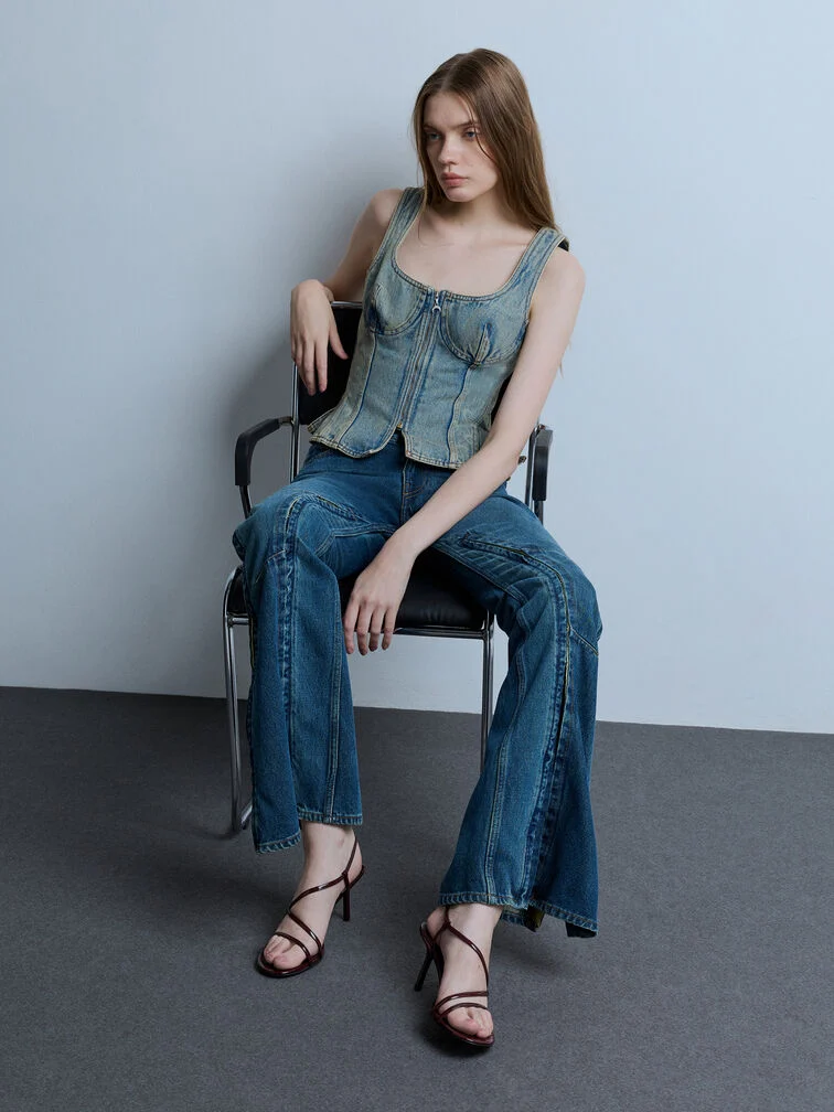 Strappy heeled sandals styled with bell-bottom jeans for a pairing that lets the dramatic flared silhouette fully stand out.