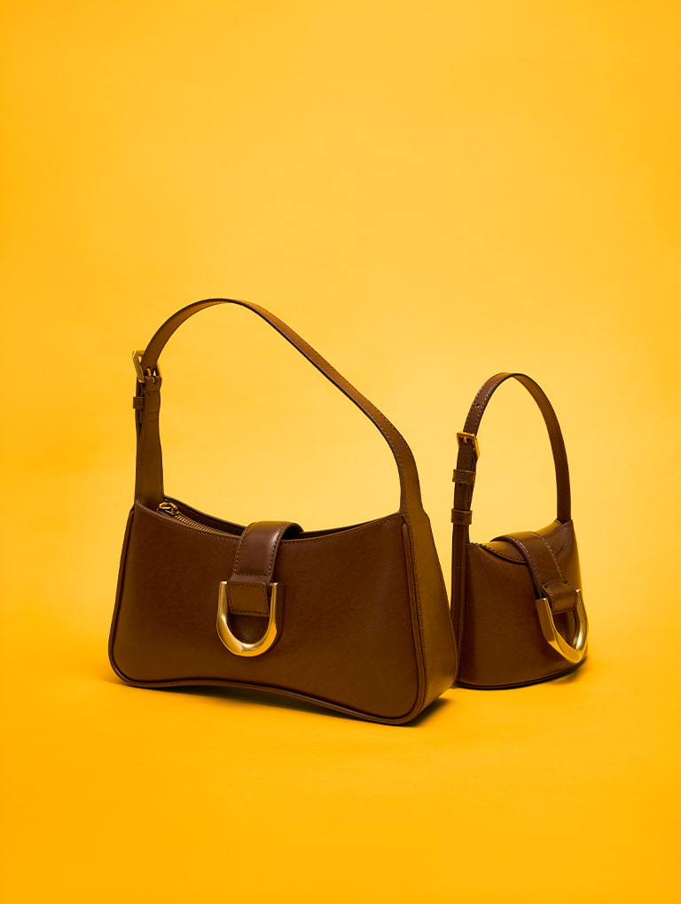 Gabine Curved Shoulder Bag and Gabine Bucket Bag, both in chocolate - CHARLES & KEITH