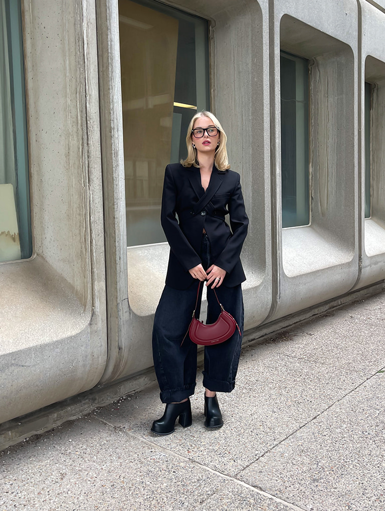Women’s Petra curved shoulder bag in red and Pixie platform mules in black, as seen on Bridget Brown – CHARLES & KEITH